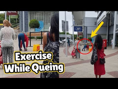 Woman Performs Exercise Routine While Queuing At The Supermarket