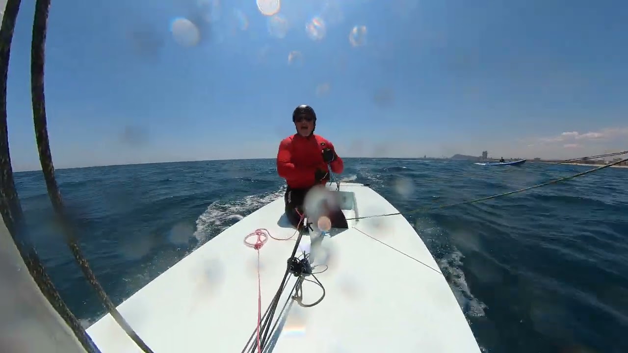 Coach says: GOOD. Gybing to the mark, tiller hand swap over shoulder, after driving down