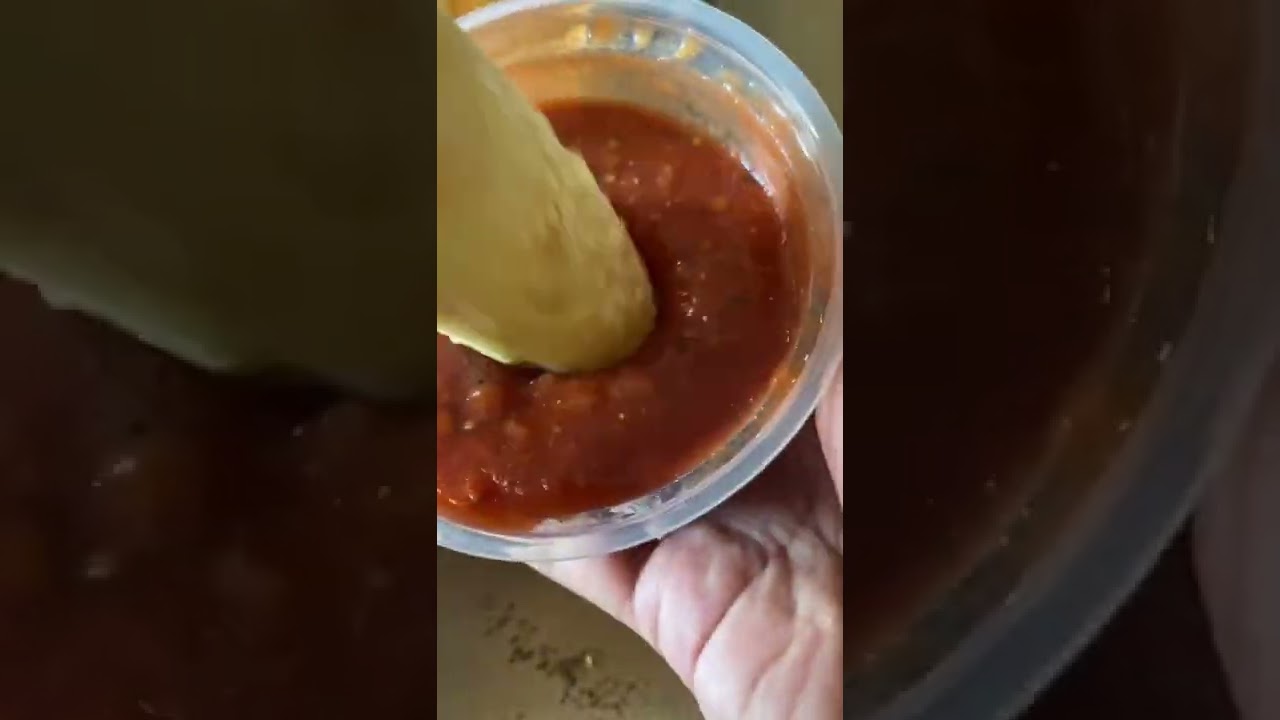 Dipping crazy bread into marinara sauce 