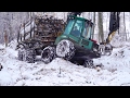 Timberjack 810B logging in snowy winter forest