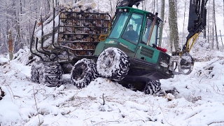 Timberjack 810B logging in snowy winter forest