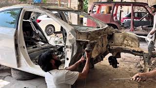 Severely Damaged White Sedan After Major Front-End Collisions