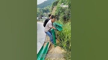 Installing a guardrail: people installing a guardrail