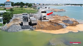 Impressive engineering feat Building a road to the middle of a lake by bulldozing and moving stones!