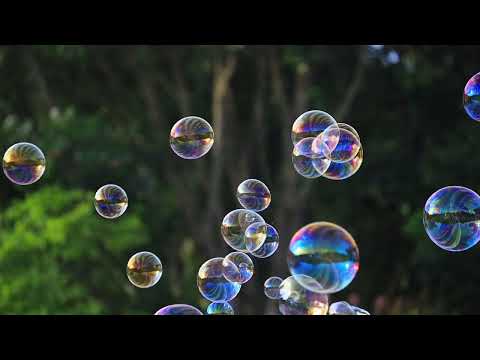 Soap bubbles floating in the air with natural green