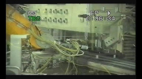 Staubli RX90 robot loading 35mm film in cameras