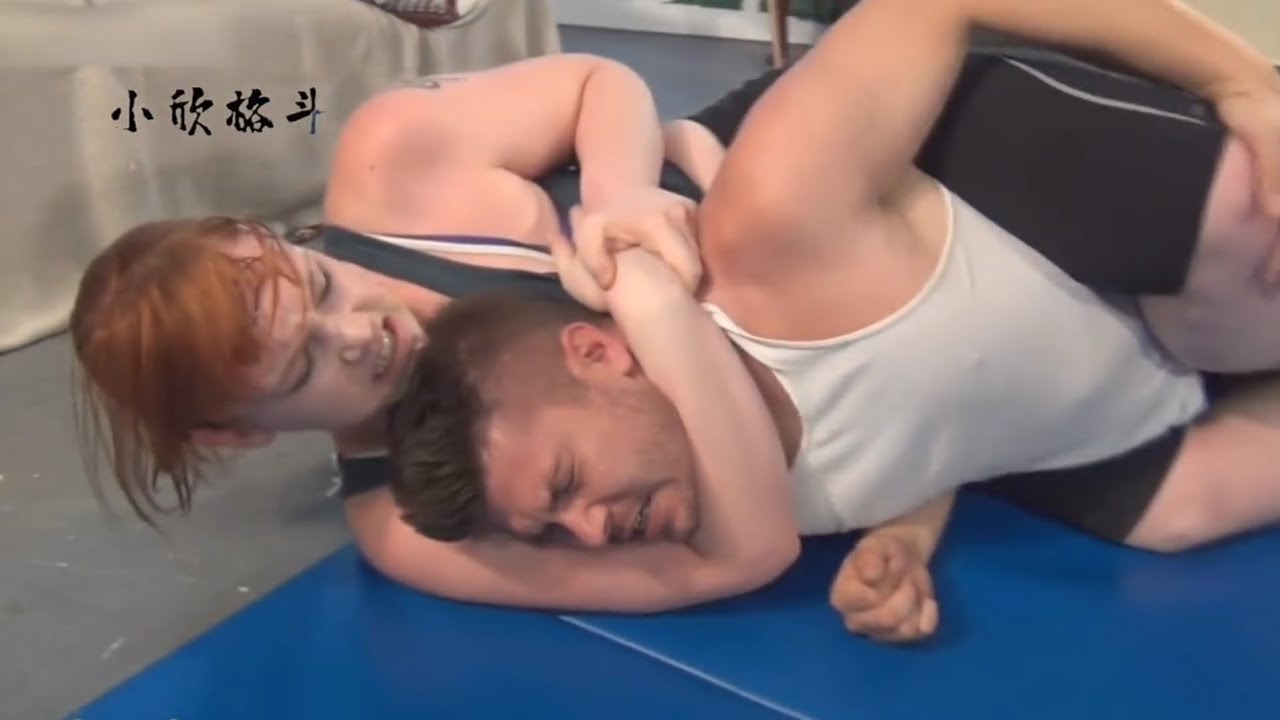 Female Wrestler Applying a Chokehold​Mixed Wrestling Submission​Man Trapped in a Sleeper Hold