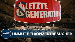 HAMBURG: Klimaaktivisten kleben sich in Elbphilharmonie an Dirigentenpult fest