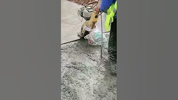 This is the process of leveling a cement mixture that has been poured at a construction site.
