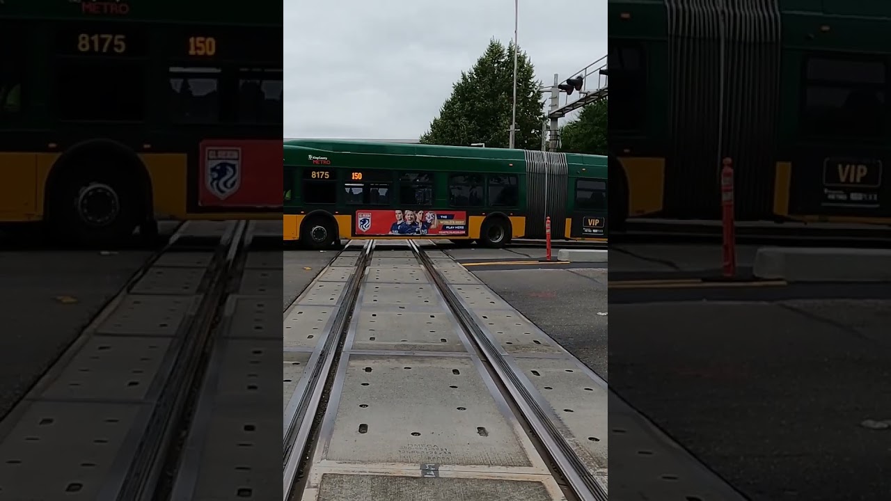 Hybrid electric powered bus crossing train tracks 