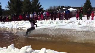 Man skis over puddle in shirt and tie (slow motion)