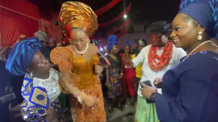 KIEKIE AND A FAN IN A DANCE BATTLE  AT ASO EBI DIARIES MOVIE PREMIERE