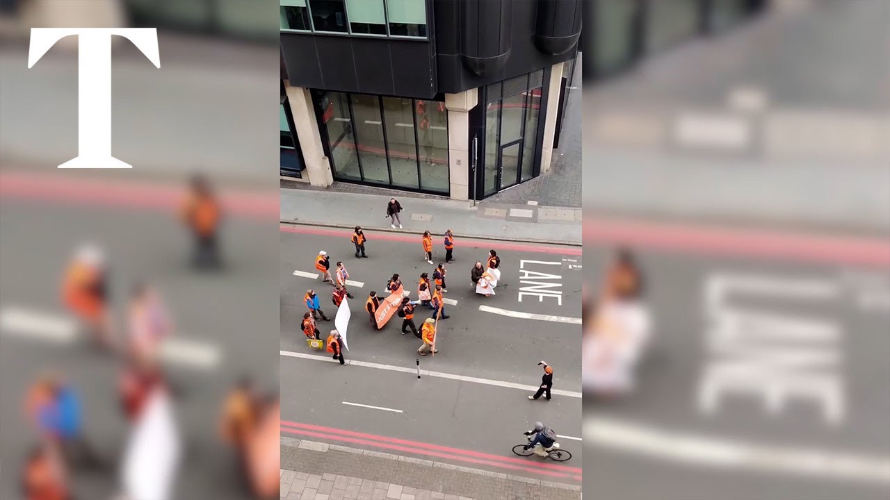 Angry passer-by shoves Just Stop Oil activist onto the ground