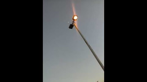 Street light on with a burned out bulb in it
