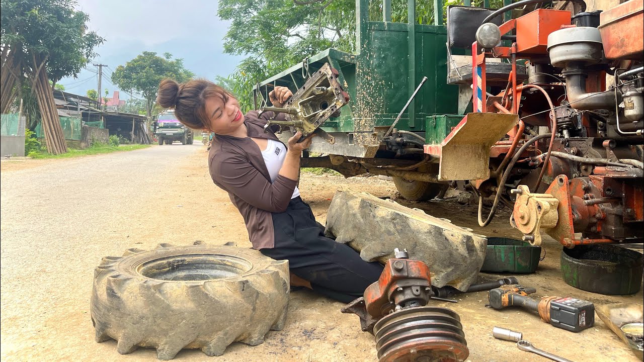 Talented female mechanic repairs and replaces tractor gear bearings