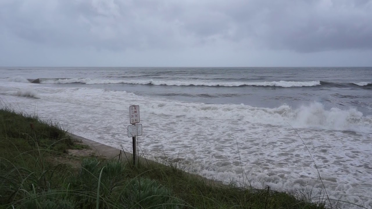 Surfers riding waves in Florida from the currents caused by hurricane Irma