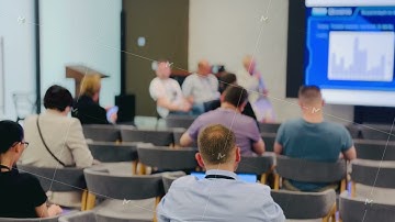 Business Professionals Attending an Indoor Conference or Workshop Panel Session