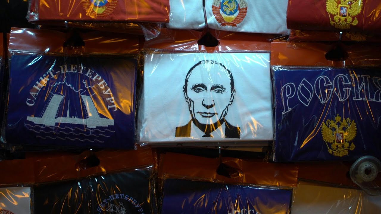 On magnets, mugs and matryoshka dolls, Putin's face still sells