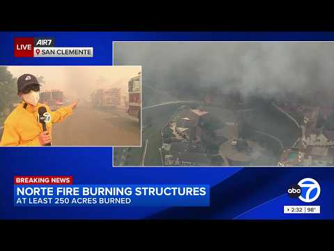 Firefighters help evacuate elderly man as fire burns dangerously close to homes