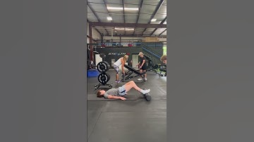 Lying Foam Roller Hamstring Bridge Walkouts