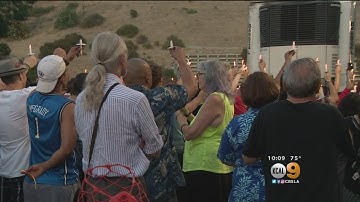 Somber Vigil Held For Trader Joe