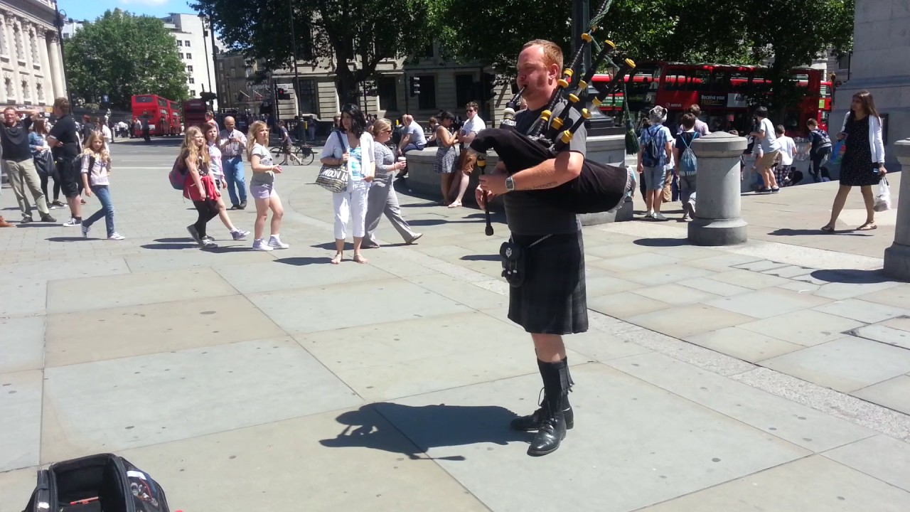 Busker with bagpipes in Trafalgar Square, London            10th June 2014