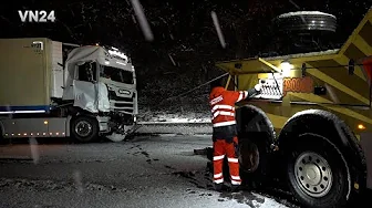 VN24 - Tow truck struggles with icy road during recovery of a truck