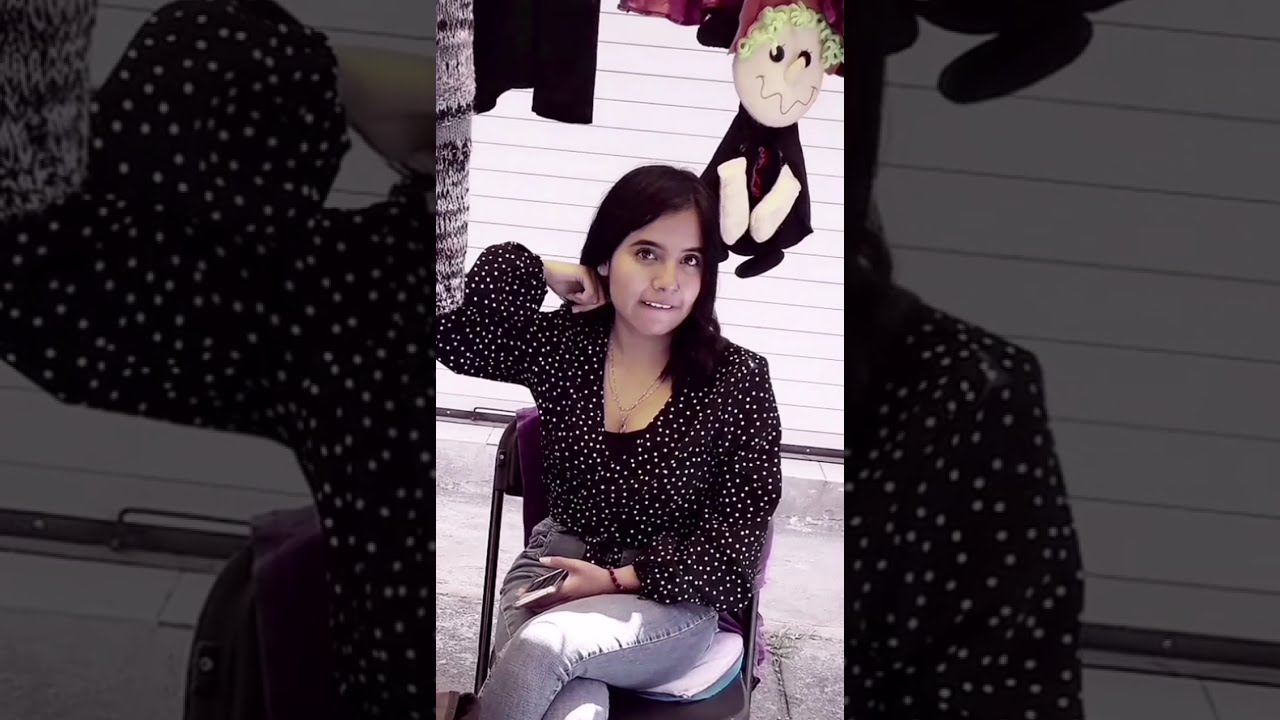 Four beautiful women chat with the same man in the market.