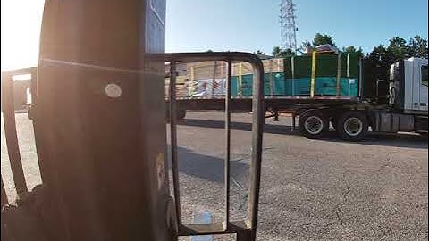 Forklift POV: Unloading Truck of Wood