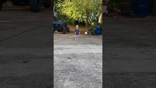 Boy in diaper runs around driveway then falls forward and faceplants on pavement near Jeep Wrangler