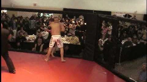 Double knock out when two fighters bust through cage door at MMA fight