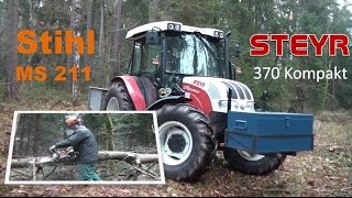 Steyr Traktor und Stihl MS 211 Kettensäge im Wald, two reliable assistants in the forest