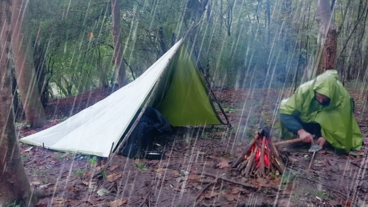 Solo camping in heavy rain and building a shelter to survive in extreme ...