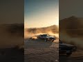 Someone driving a car in a desert
