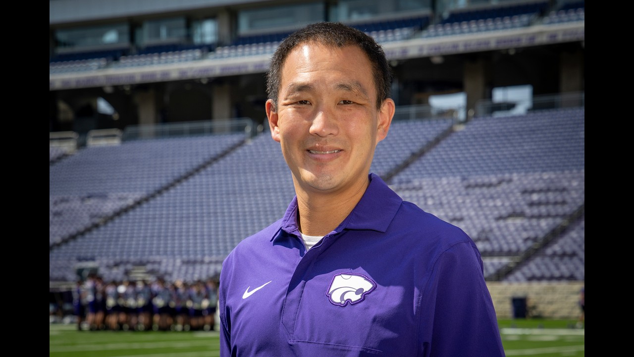     Dr. Alex Wimmer standing inside of Bill Snyder Family Stadium.