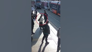 Incredible moment security guard stops woman from walking in front a tram