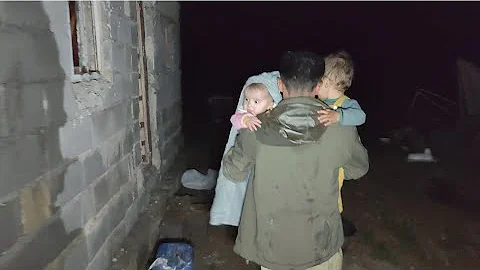 Forced sheltering in a half-built hut:tent gets wet in rain at night