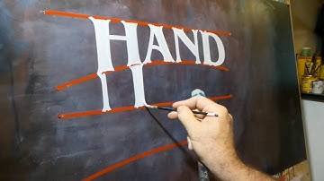 Hand lettering by John King. Freehand ITC Benguait.