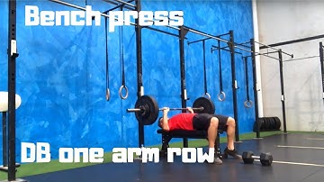 Superset bench press and one arm row