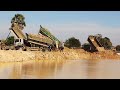 Big pond filling processing using dirt and rock operating by bulldozer with dump trucks