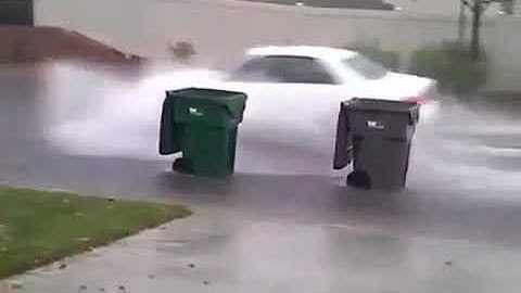 Funny trash cans roll down road during huricane