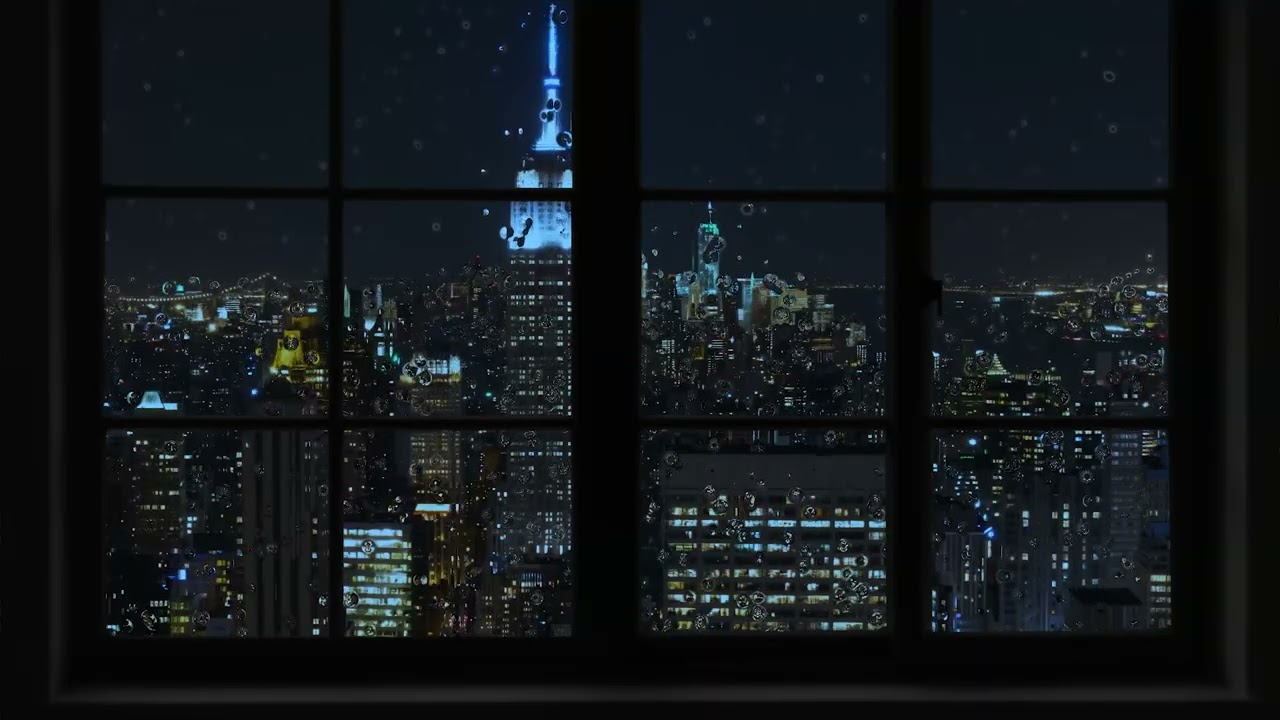 Rain blankets the brightly lit city - Sleeping peacefully behind the window