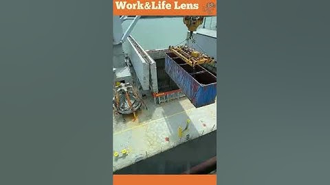 Crane loading grain into a ship by lifting container and releasing hatches #efficiency