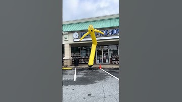 Wacky Arm Waving Inflatable Tube Man loves books