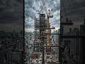 Tower crane lifting steel beams 202605170854