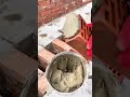 A mason’s hands swiftly stack the bricks into a straight, even wall