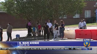 Protesters gather near Newton police station