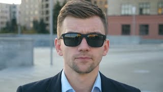 Portrait of Young Businessman in Sunglasses Walking in City Street. Handsome Business Man Stepping