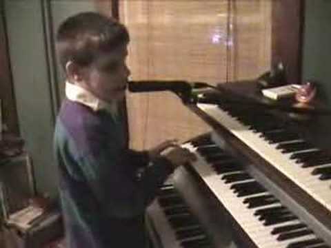 Blind Child playing and singing Rudolf the red nose raindeer - YouTube