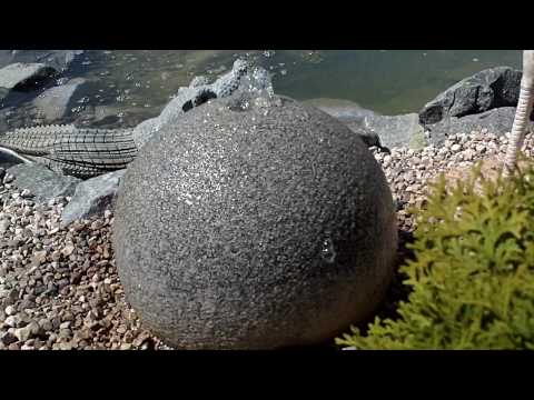 Large spherical rock fountain shoots water